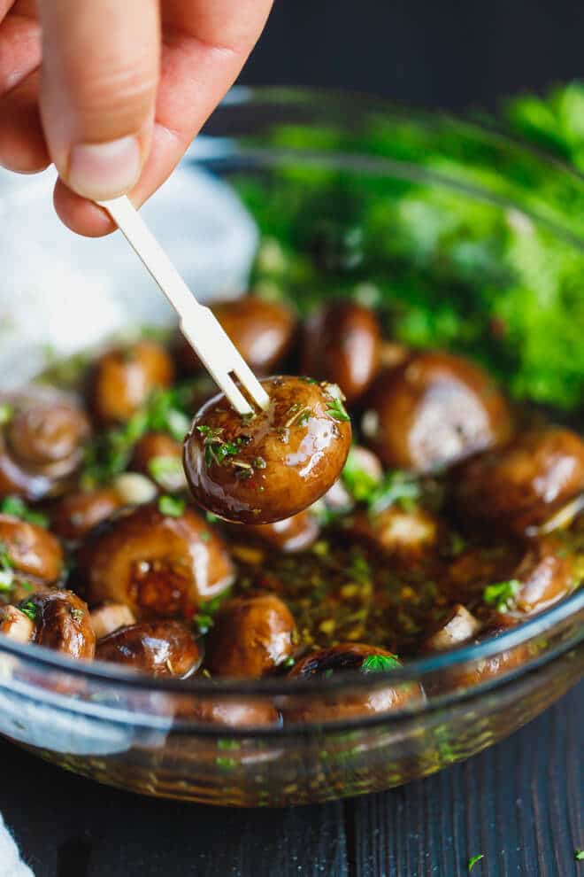 Marinated mushroom on a wooden appetizer pick