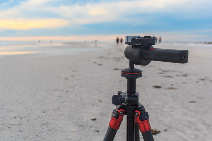 A tripod set up on a beach for landscape nature photography