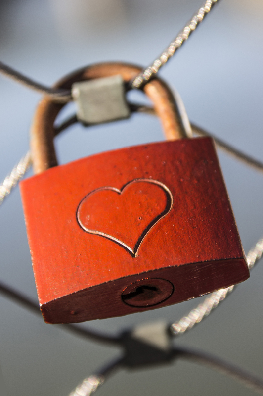 Brown padlock with an engraved heart.