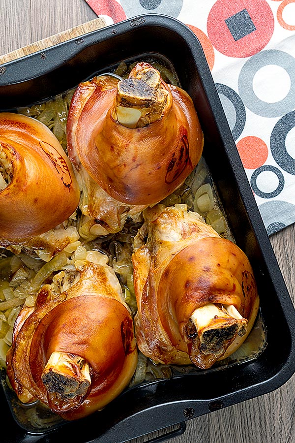 Schweinshaxe (German Roast Pork Knuckle) in roasting pan overhead image